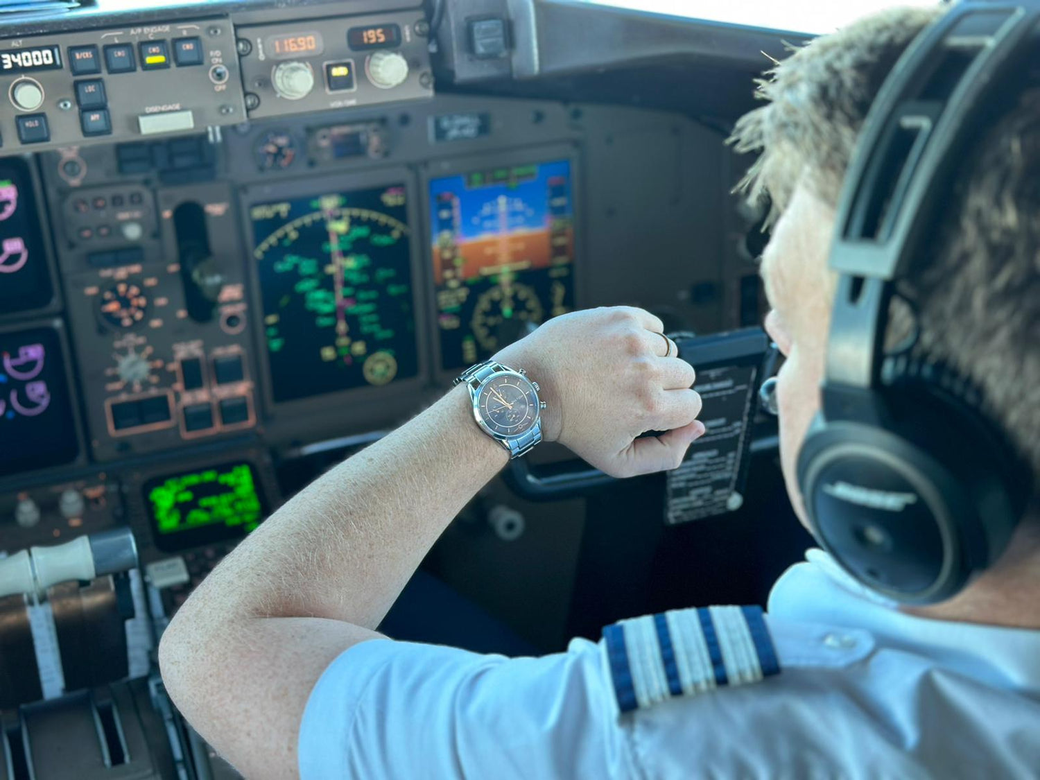 Airline Captain Sam Kettle wearing a Diatom Watch with Airplane command module in background