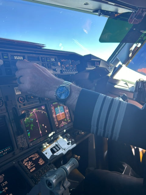 Diatom Watch with Airplane Command Module in Background