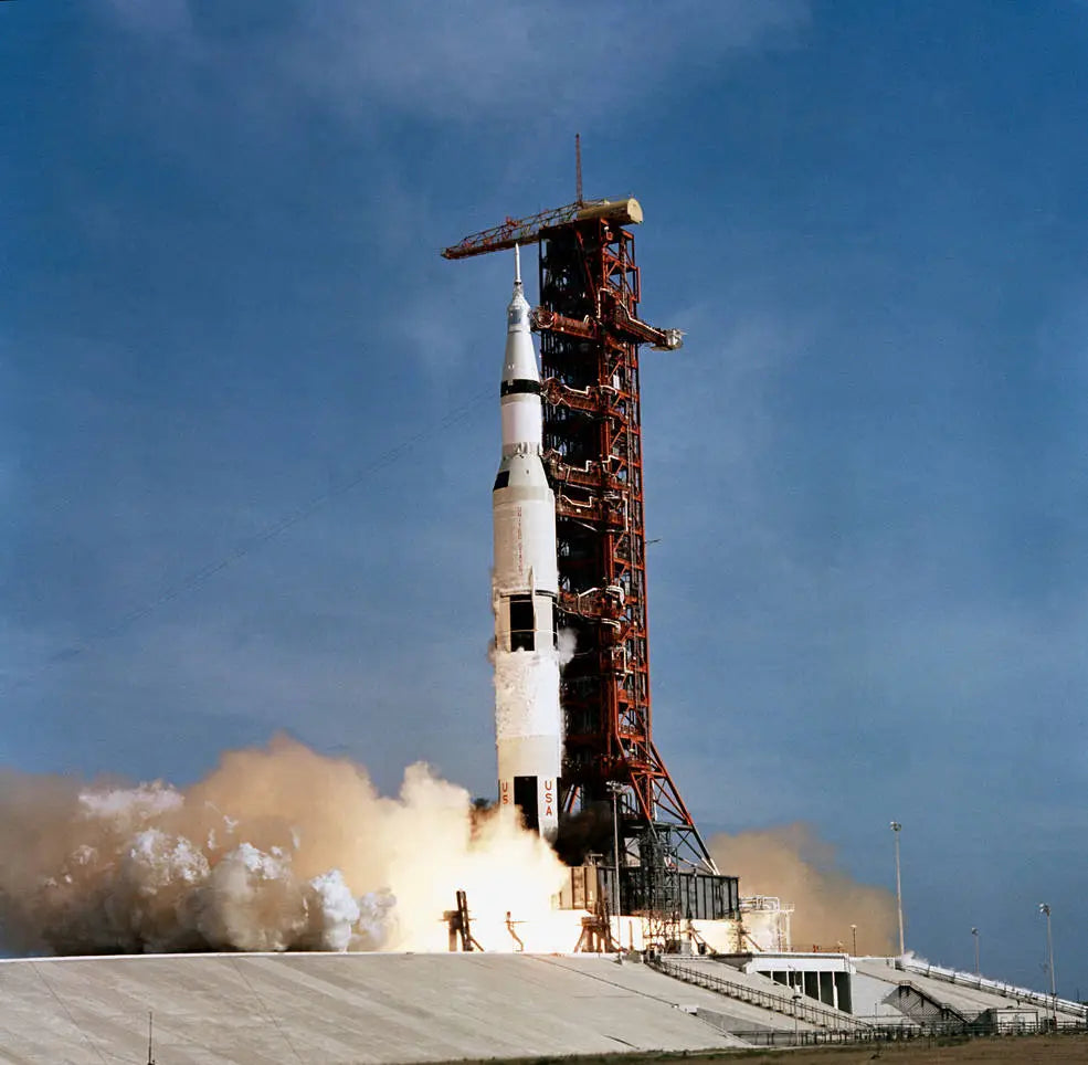 Apollo 11 launch with Kapton materials used in the timepiece legacy, showcasing the rocket at liftoff.